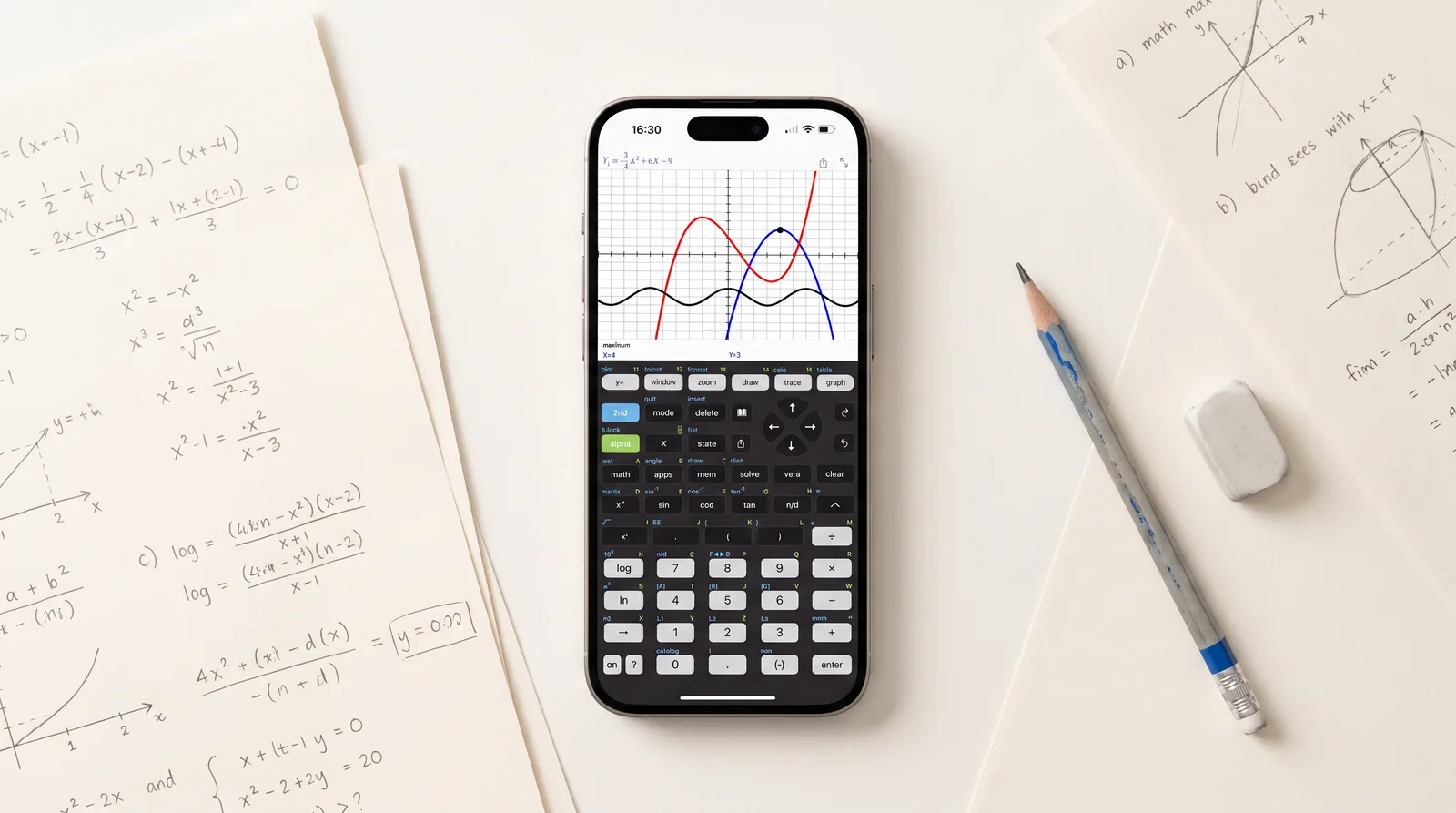 A smartphone on a desk running the Taculator 84 graphing calculator app